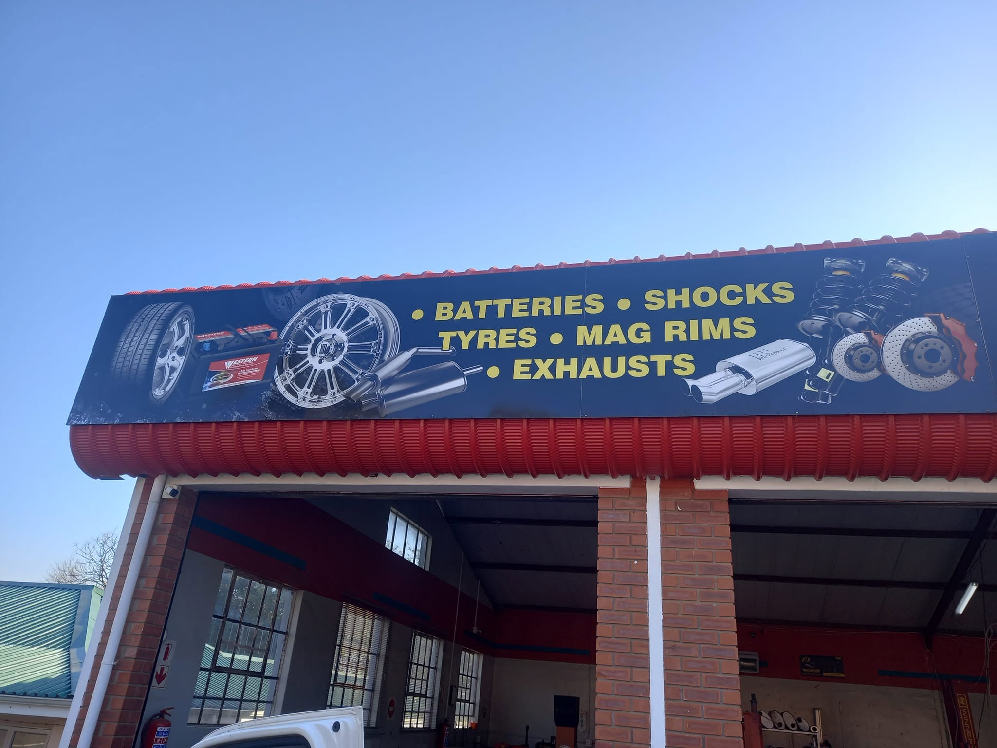 Open service bays at Peters Safety Kwik Fitment Centre showing professional workshop equipment